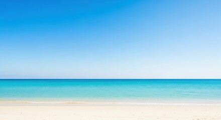 Serene ocean horizon with soft sand beach under a bright blue sky
