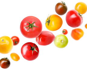 Different fresh tomatoes falling against white background