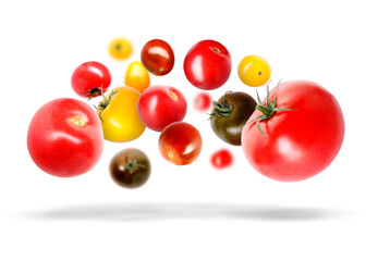 Different fresh tomatoes falling against white background
