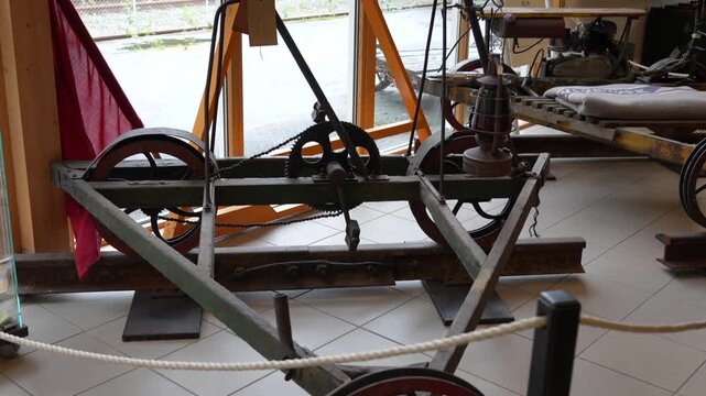 Camera pan across a vintage rail inspection draisine at Fl&aring;m Railway Museum, Norway, showcasing historical engineering and manual track maintenance design.