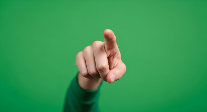 Man hand pointing or touching on chromakey isolated on green screen background. Interactive digital display.