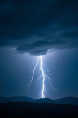 A spectacular, branching lightning bolt dramatically lights up the night sky and strikes distant mountain peaks