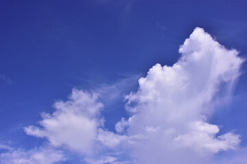 Large cumulus white cloud rising in a vibrant deep blue sky, creating a dramatic and peaceful atmosphere. A natural tropical sky scene from Bangladesh