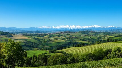 Obraz premium Stunning Italian countryside landscape with rolling hills and snow capped mountains