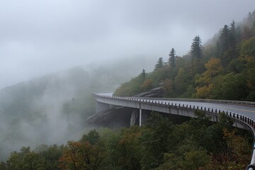 Fototapeta premium Mountain road bridge in misty foggy landscape