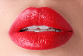 Obraz premium Woman with beautiful red lipstick on her lips, macro view