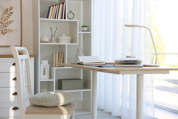 Stylish living room with table, chair and shelving unit. Interior design