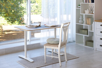 Stylish living room with table, chair and shelving unit. Interior design