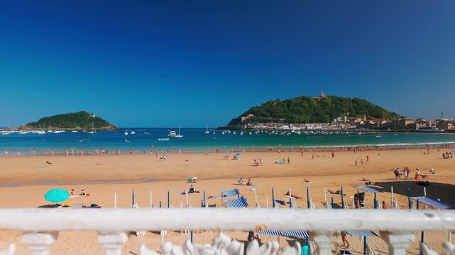 La Concha Beach with turquoise sea and iconic white fence in Donostia Spain