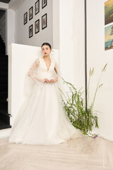 stylish woman posing in stunning white dress