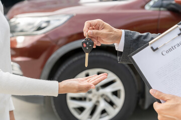 lease, rental car, sell, buy. Dealership manager send car keys to the new owner. Sales, loan credit financial, rent vehicle, insurance,  renting, Seller, dealer, installment, car care business