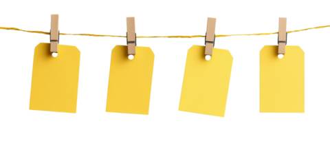 Four yellow blank tags hanging on string with clothespins