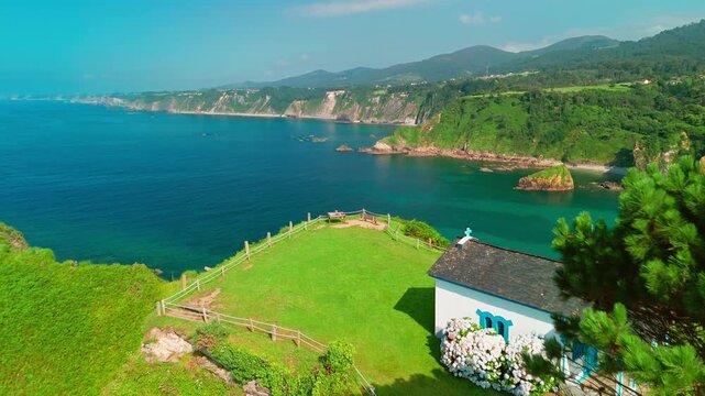Aerial view of a Ermita de la Regalina on the steep cliffs in Asturias, Spain