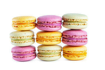 Stack of colorful French macarons isolated on white background.