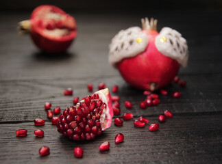 A beautiful ripe pomegranate on a dark wooden table. A variety of conceptual photos of pomegranates. Variable ideas for creating a look.