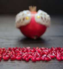 A beautiful ripe pomegranate on a dark wooden table. A variety of conceptual photos of pomegranates. Variable ideas for creating a look.