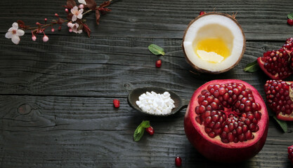 A beautiful ripe pomegranate on a dark wooden table. A variety of conceptual photos of pomegranates. Variable ideas for creating a look.