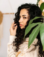 Woman with curly hair and sweater