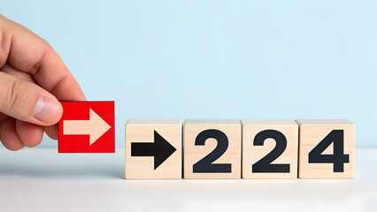 Hand placing red arrow block next to wooden number blocks two twenty four