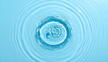 Concentric ripples expanding from a central point on a light blue liquid surface