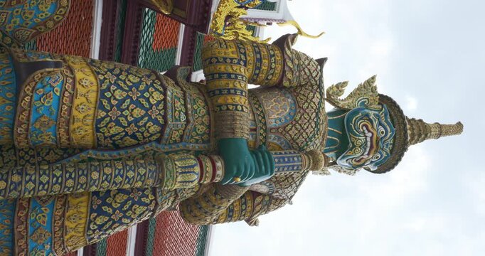 Giant guardian statue at Temple of the Emerald Buddha or Wat Phra Kaew in Bangkok, Thailand.