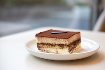 Square Tiramisu served on plate in the cafe