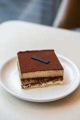 Square Tiramisu served on plate in the cafe