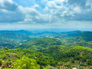 Stunning panoramic view of green hills and valleys in Mallorca during a cloudy afternoon in early spring