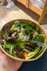 Caesar salad served in cardboard packaging, representing fresh and convenient fast food for takeaway or delivery.
