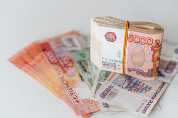 Close-up view showcases a variety of Russian rubles, highlighting the prominent 5000 note, ideal for illustrating currency, finance, and economic themes.