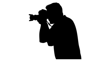 Silhouette of a person holding a camera and taking a photograph.