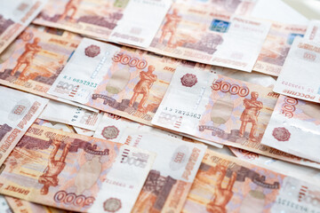 Obraz premium A collection of Russian ruble banknotes laid out on a flat surface highlights the significance of currency in everyday transactions and economic activities.