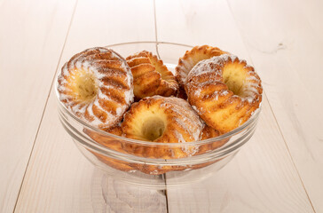 Sweet homemade cupcakes on a wooden table, close-up.