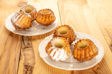 Sweet homemade cupcakes on a wooden table, close-up.