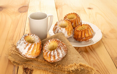 Sweet homemade cupcakes on a wooden table, close-up.