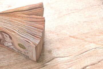 close up of Thai thousand banknote arranging on woodentable background and texture