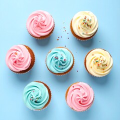 Cute pastel cupcakes with frosting swirl and sprinkles on a clean background, flat lay photography