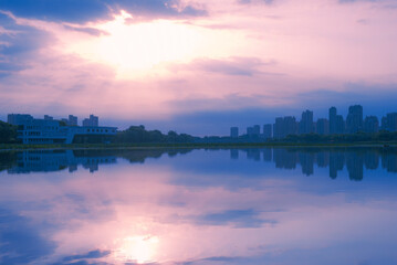 Fototapeta premium Urban architecture, bridges, river landscapes, and beautiful city skyline under the sunset