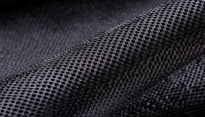 a close up of a black mesh fabric with a circular knit pattern highlighting the texture weave structure and breathability ideal for textile and design references