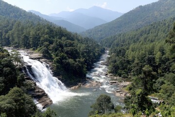 A tranquil waterfall cascades down rocky cliffs, surrounded by lush, green forests and a winding river.