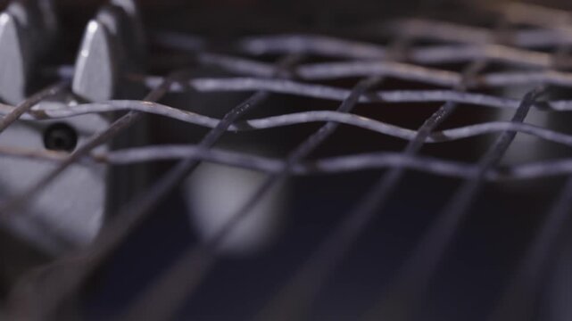 Manual stringing of a tennis racket on machine