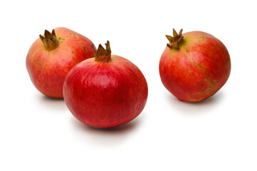 Three juicy pomegranates isolated on white background