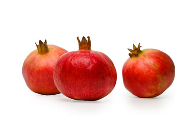 Trio of juicy pomegranates on white background, isolated