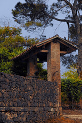 A beautifully scenic stone archway is surrounded by lush and vibrant greenery all around