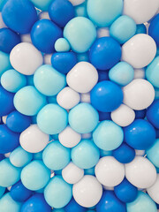 Background of balloons of various sizes in shades of dark blue, light blue, and white. Handmade balloon backdrop arranged tightly in dark blue, light blue, and white for decoration.