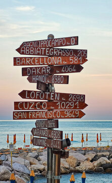 Wooden Signpost with City Distances on Ligurian Beach
