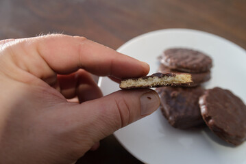 Biscuits covered with chocolate on both sides on a white plate