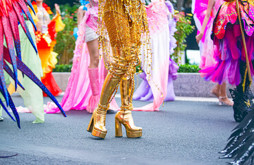 A cropped photo shows the lower body of female participants at the Nha Trang Sea Festival parade, featuring elements of their costumes, detailed accessories, and extravagant footwear.
