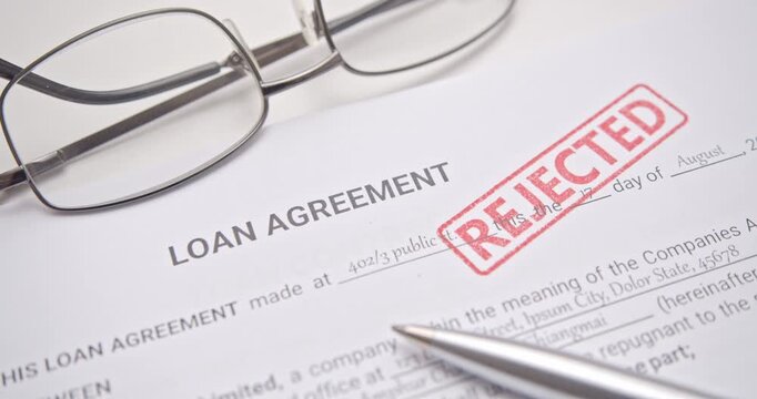 Loan Application Rejected with Red Stamp on Financial Agreement