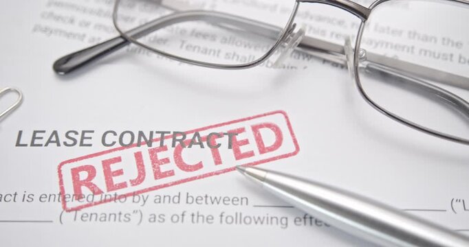 A close-up video of a lease contract form being stamped with a red &ldquo;REJECTED&rdquo; mark, symbolizing denied applications, failed approval, rental issues, or financial disqualification in property leasing.